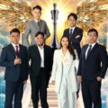 Six professionals in business attire stand on a stairway with a glowing trophy and golden wings behind them conveying achievement and teamwork